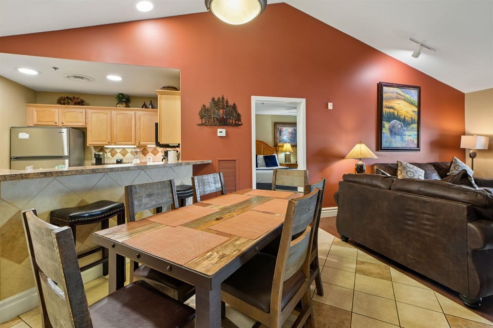 Gather around your spacious dining table for memorable meals while enjoying the warm ambiance of your fully equipped kitchen and comfortable living area.