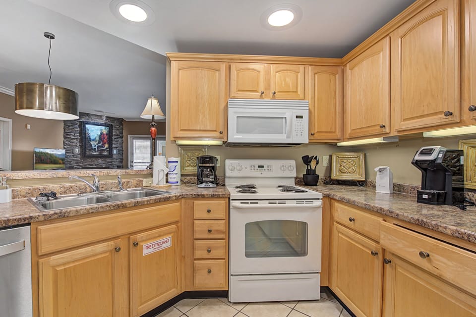 Your fully equipped kitchen offers granite counters, quality appliances, and warm wood cabinetry for preparing memorable meals together.