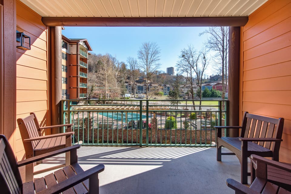 Step onto your private balcony and soak in stunning pool views while sipping morning coffee from comfortable wooden chairs.