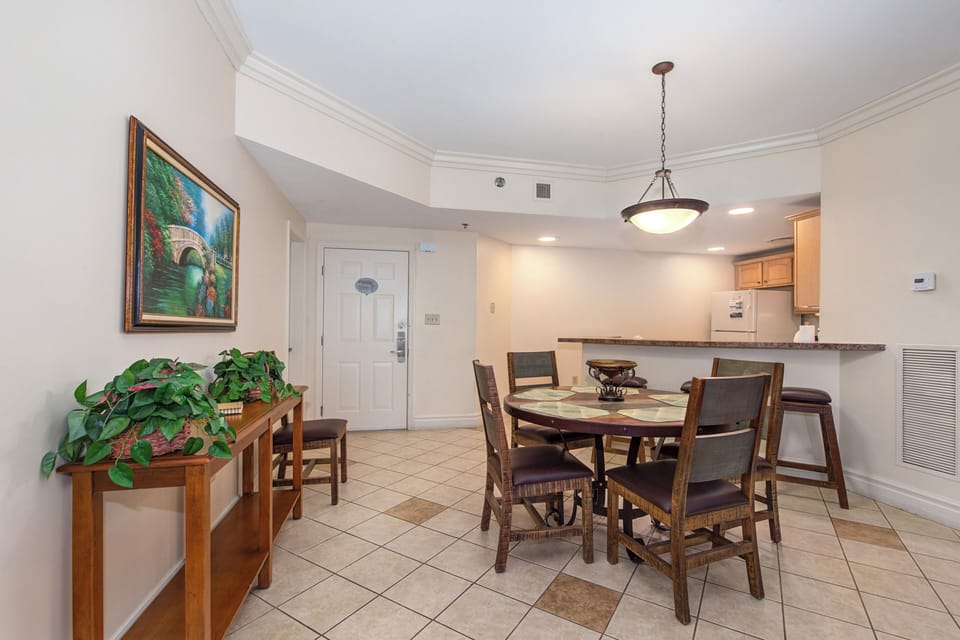 Your elegant dining space welcomes gatherings around the handsome wood table, while the open kitchen invites culinary adventures.