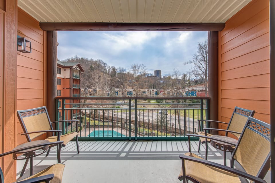 Step onto your private balcony and unwind in comfortable seating while enjoying peaceful pool views and the surrounding neighborhood.