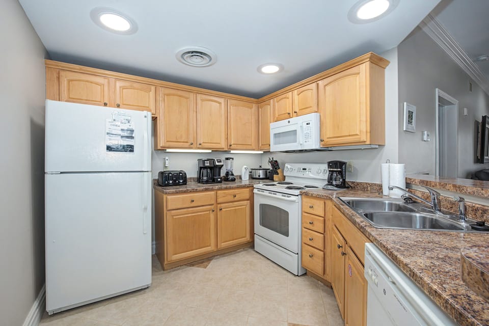 Your fully equipped kitchen features warm wood cabinets, granite countertops, and all the appliances you need to create memorable meals.
