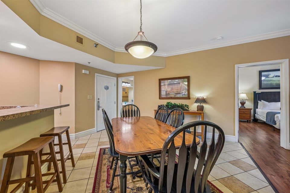 Gather around this welcoming dining space where warm wooden tones and comfortable seating create the perfect setting for your family meals.