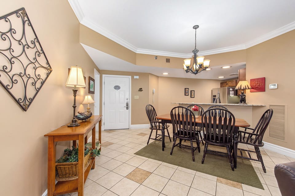 Gather around your elegant dining table for memorable meals in this warm, inviting space with beautiful tiled floors and charming decor.