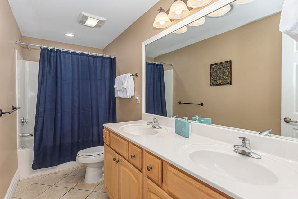 Freshen up in your spacious bathroom with dual sinks and a relaxing tub-shower combo for ultimate comfort.