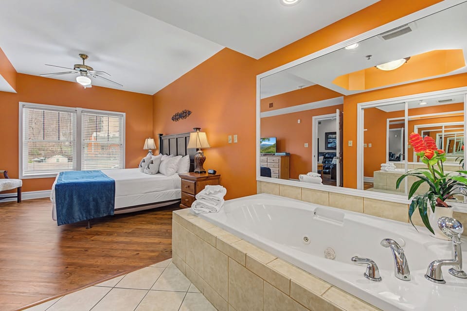 Unwind in your luxurious suite featuring a romantic jetted tub and plush king bed, perfect for an intimate getaway.