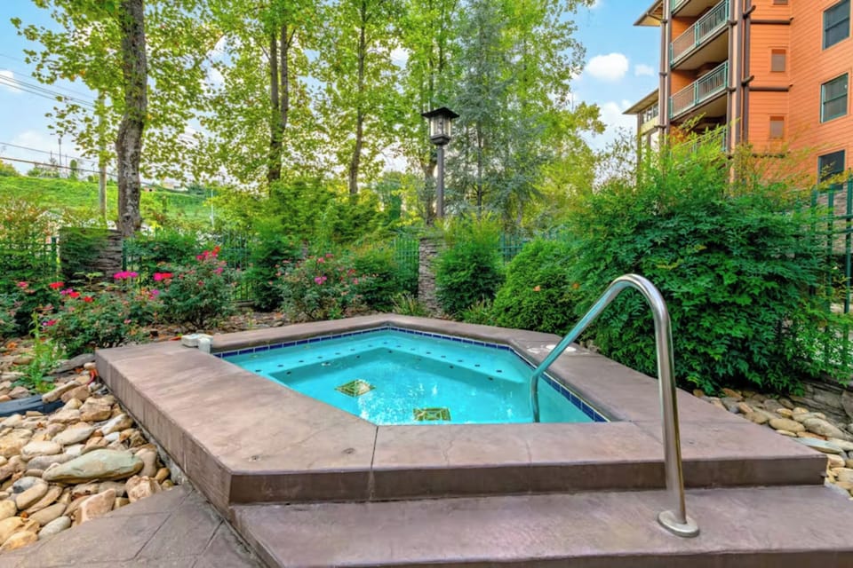 Soak your worries away in this private hot tub, surrounded by lush gardens and vibrant blooms for the ultimate relaxation retreat.