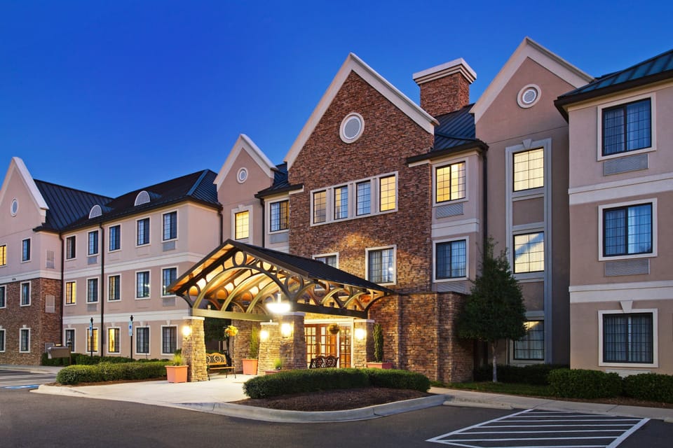 Charming hotel facade featuring a cozy, well-lit entrance at dusk.
