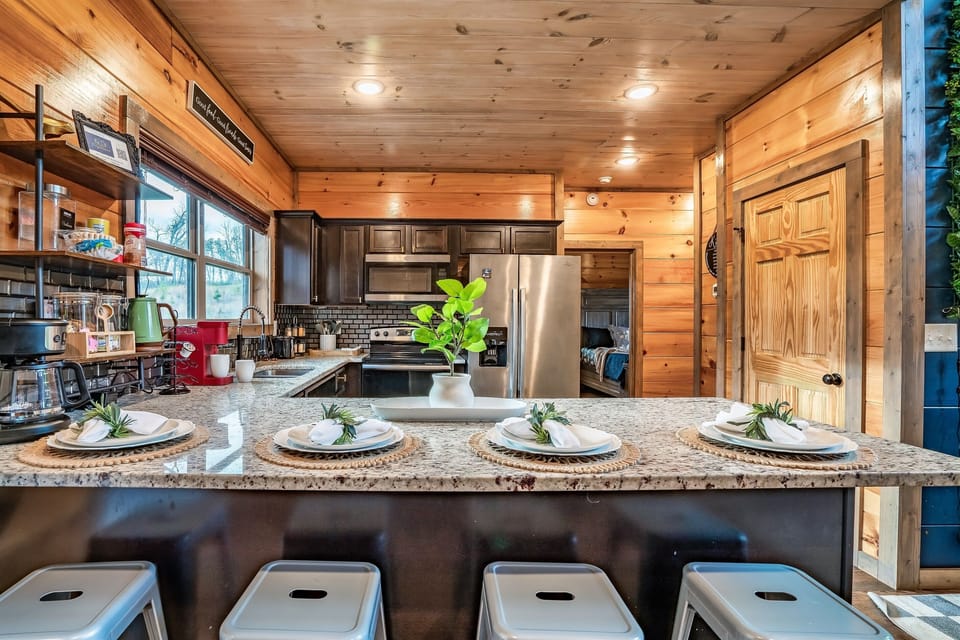 Gather around the kitchen island for meals, coffee, or conversation in this warm and welcoming space.
