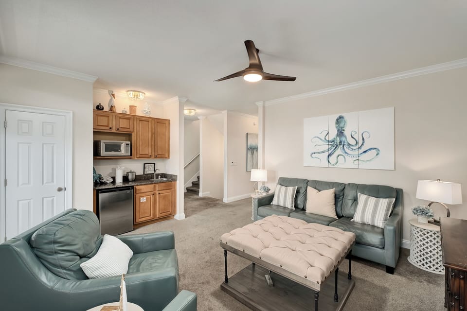 Unwind in your coastal-inspired living space, complete with a kitchenette for easy meal prep and comfortable seating perfect for quiet evenings. The ceiling fan keeps you cool after sunny beach days.