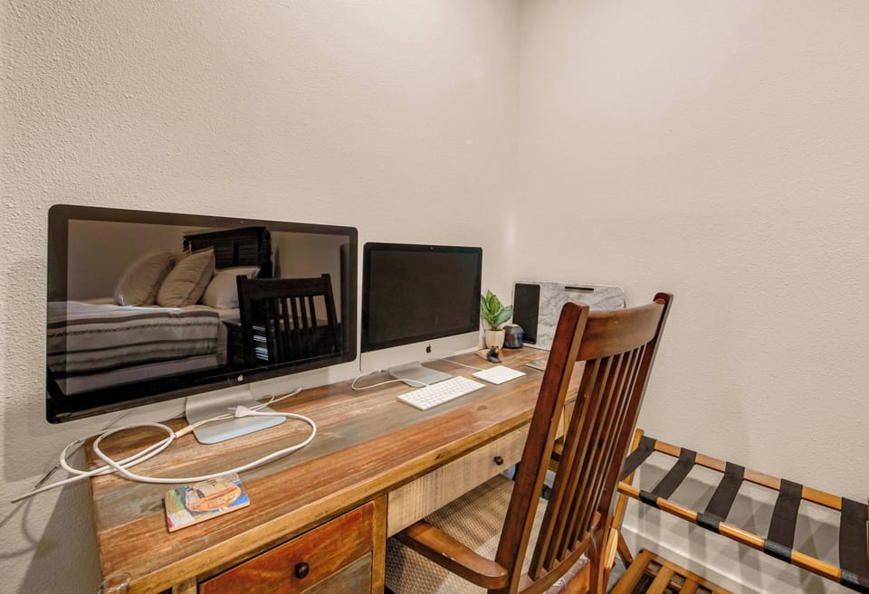 The primary king suite boasts a smart TV, a luxurious ensuite, & ample storage​