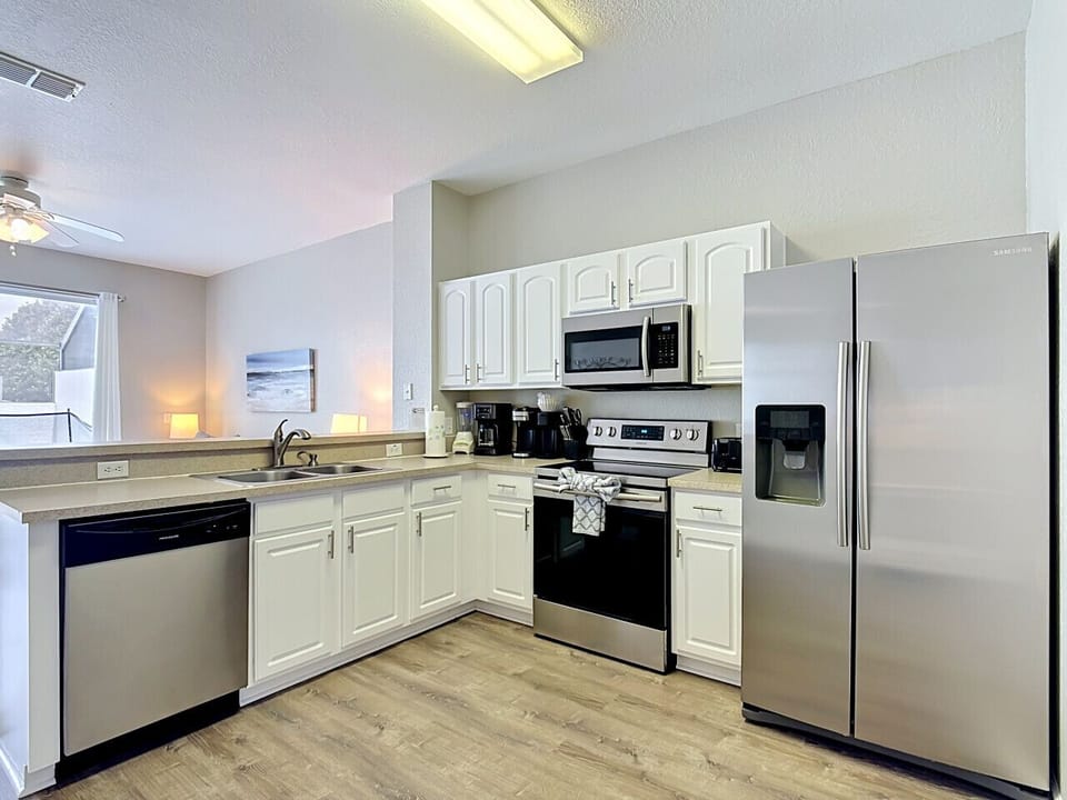 Modern kitchen with stainless steel appliances and ample counter space.