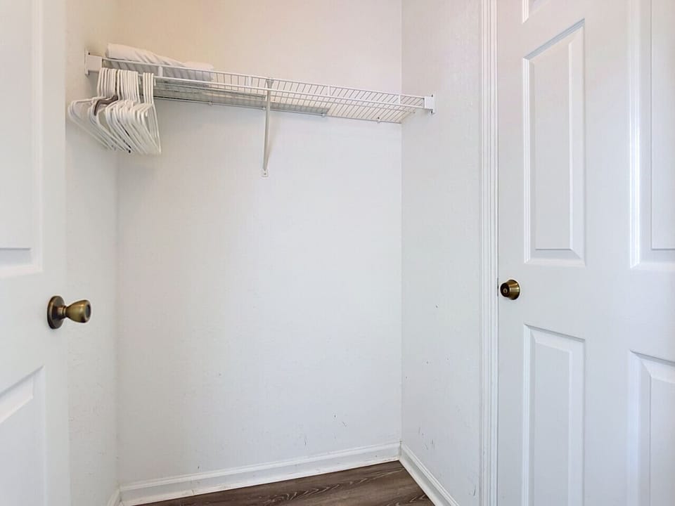 Closet with hanging space and storage shelves.