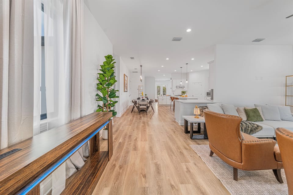 Hallway view leading into the open living and kitchen area, showcasing the home’s bright and airy layout.