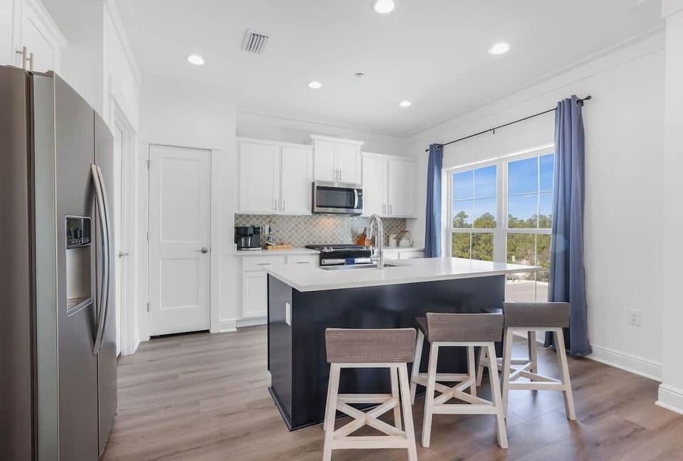 Large kitchen with pantry and bar seating for 3