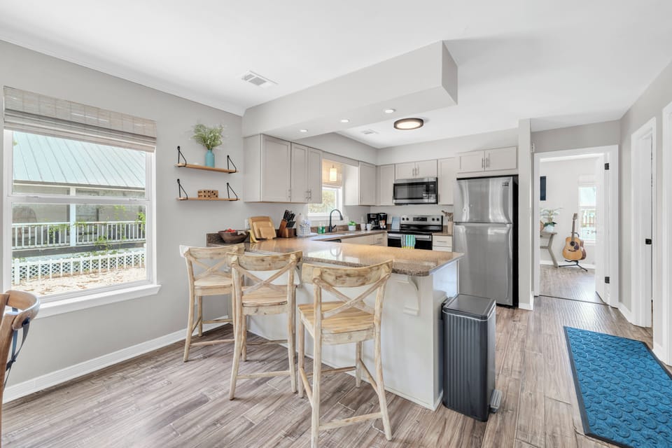 Your modern kitchen features granite countertops, stainless steel appliances, and a breakfast bar perfect for morning coffee.