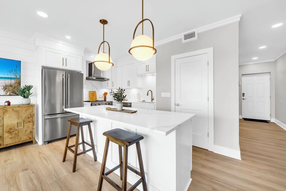 Your modern kitchen awaits with gleaming quartz counters, stainless appliances, and cozy bar seating perfect for morning coffee or evening wine.