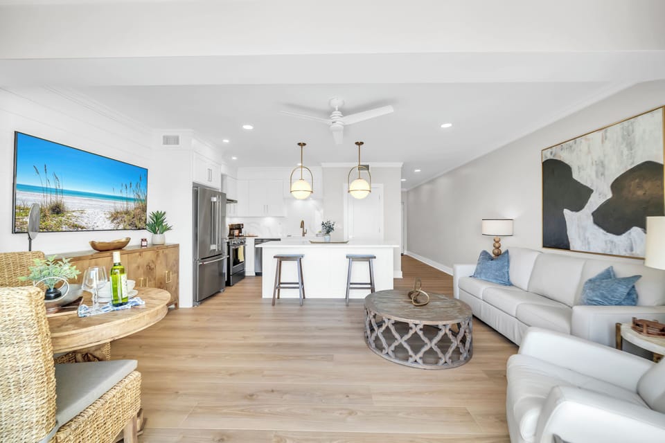 Relax in your bright, open-concept living space with coastal charm, modern kitchen, and beachy décor that makes you feel at home.