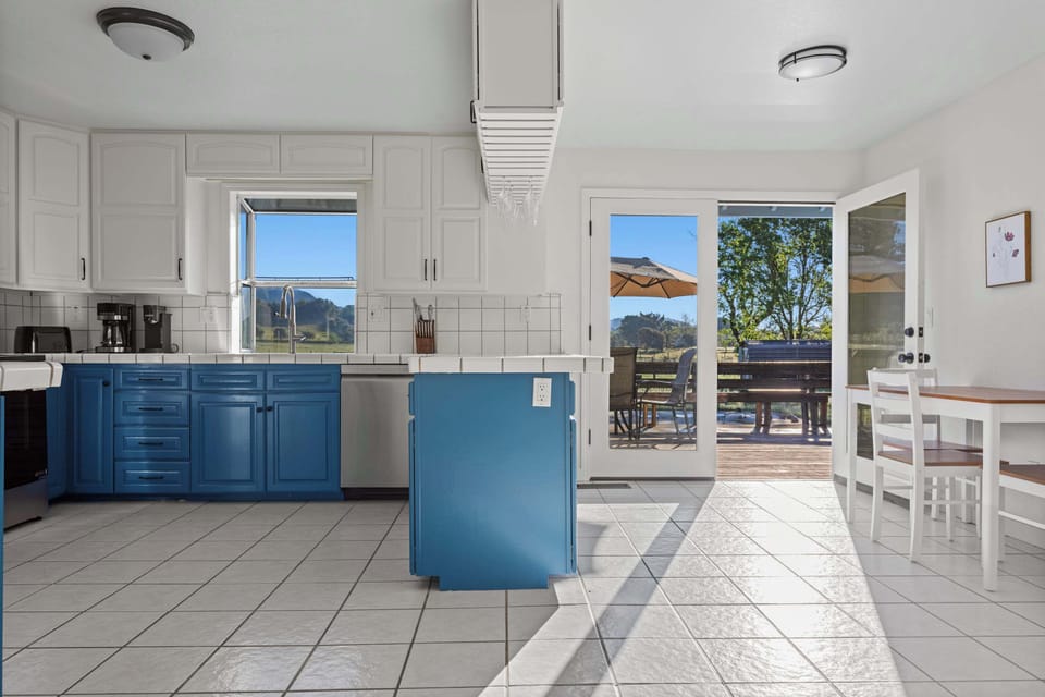 Seamless indoor-outdoor flow—step straight from the newly renovated kitchen to the deck for a sunset meal under the umbrella.