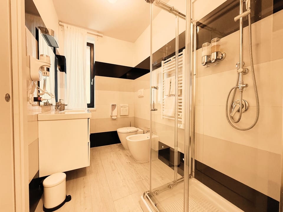 Deluxe Triple Room, Patio, Garden View | Bathroom | Shower, bidet