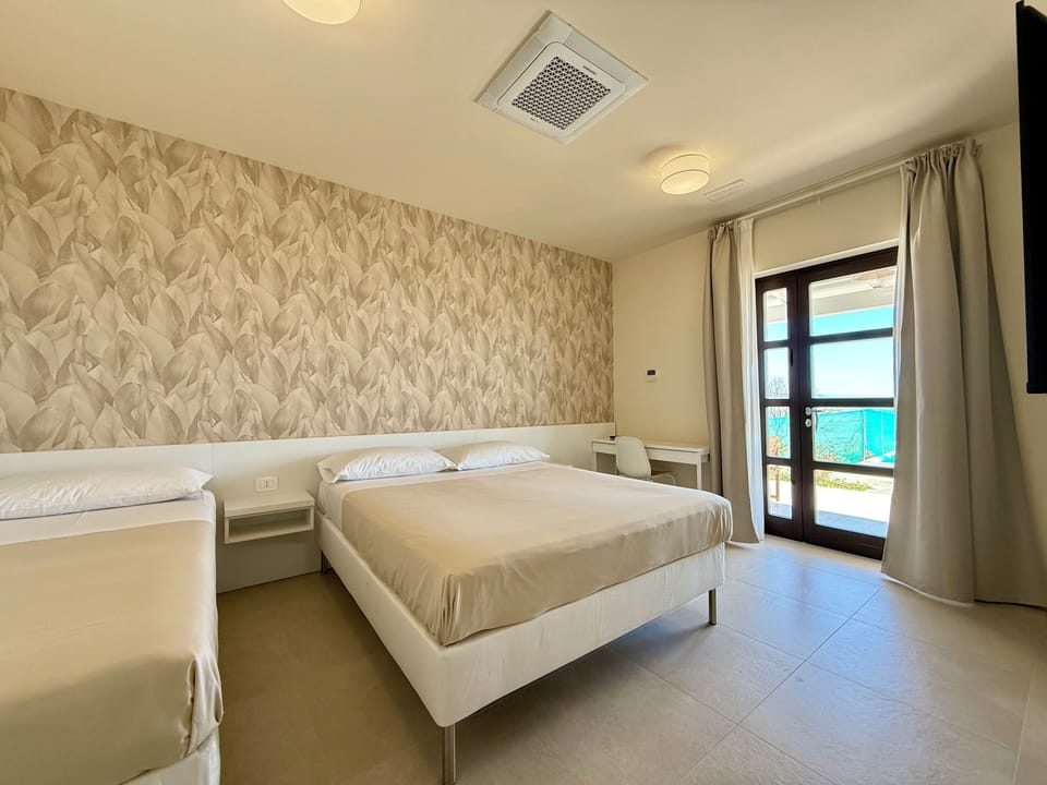 Deluxe Triple Room, Patio, Garden View | In-room safe, blackout drapes, free WiFi