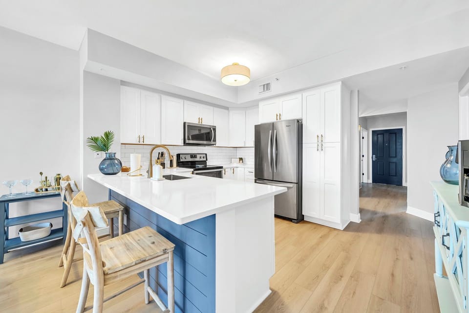 Cook, gather, and connect in this bright, fully equipped kitchen featuring modern appliances, spacious countertops, and bar seating—perfect for everything from quick breakfasts to family meals.