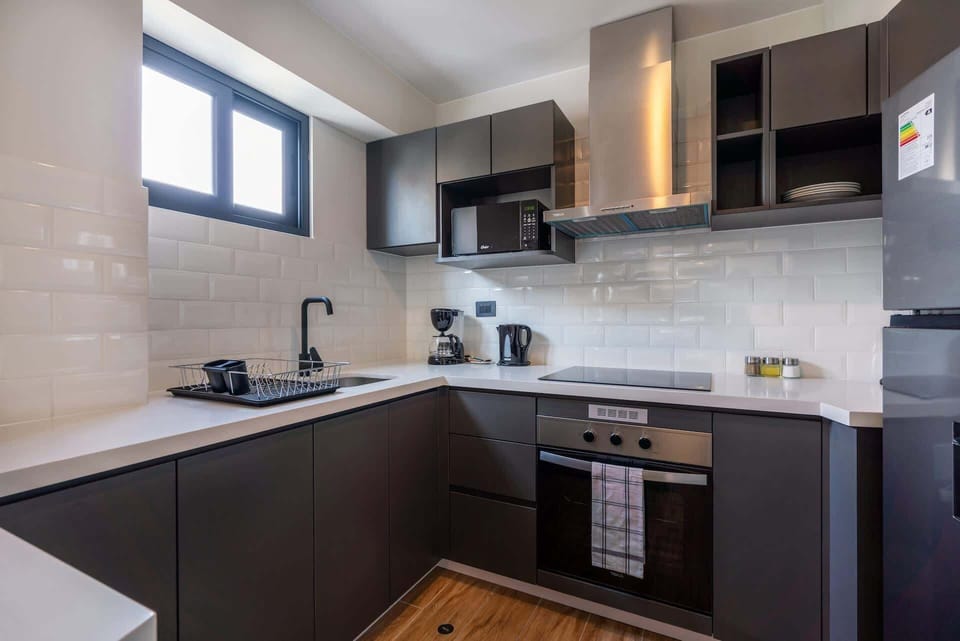 Fully equipped kitchen with sleek cabinetry, ample counter space, and modern appliances.