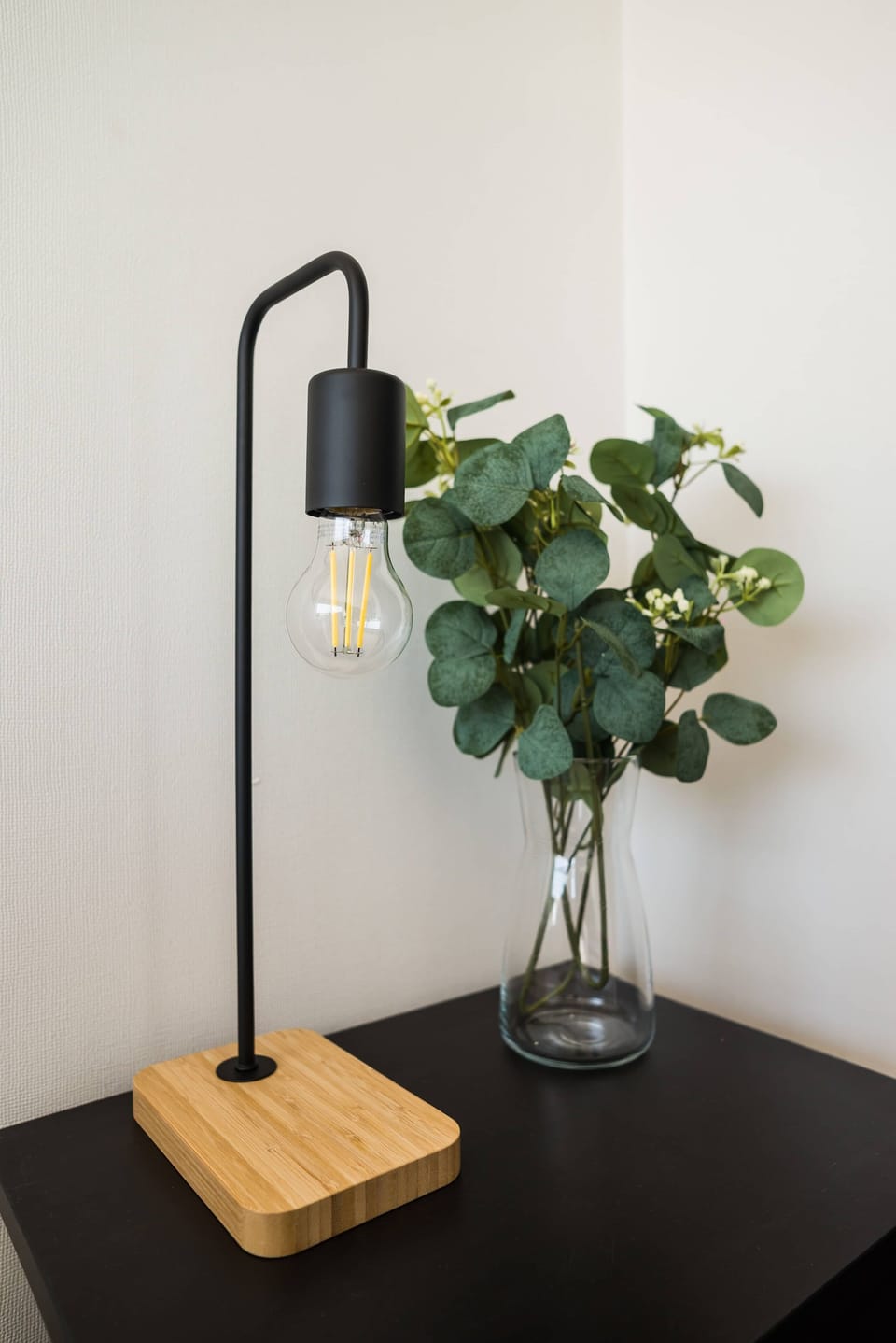 Stylish modern lamp and greenery add a touch of elegance to your stay.
