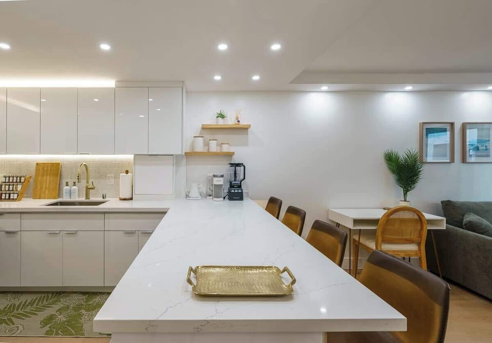 Full kitchen with modern stainless steel appliances including a dishwasher. Coffee maker will use K-cups.
