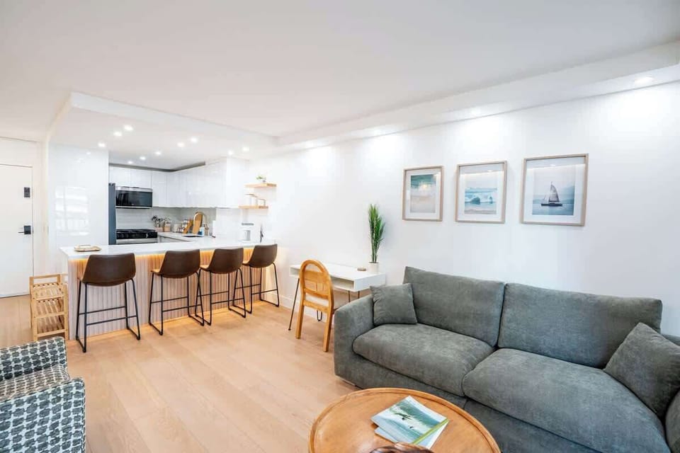 The lighting, large sofa, and abundance of seating,  anchors this spacious living room area for relaxing conversations.