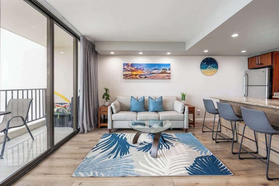 The lighting and leather sofa anchors this spacious living room area for relaxing conversations. 