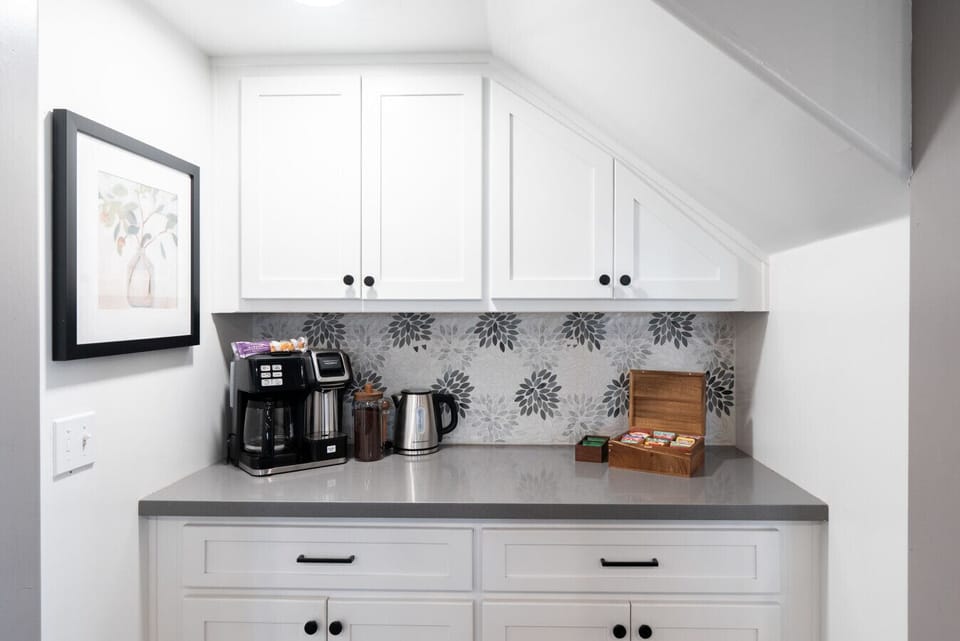 Dedicated beverage station with coffee, tea, and hot water ready for guests