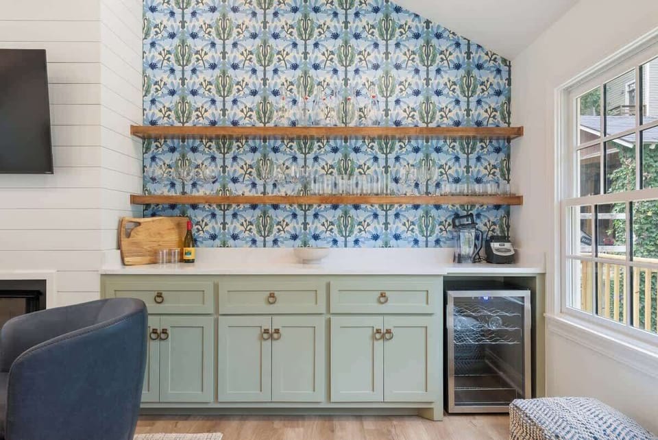 Stylish bar nook w/ open shelving, bold tile & seating nearby