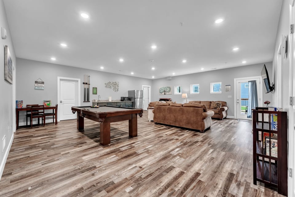 Game Room with Pool Table, Couches, Games, Table, Refrigerator, Micro Wave. 