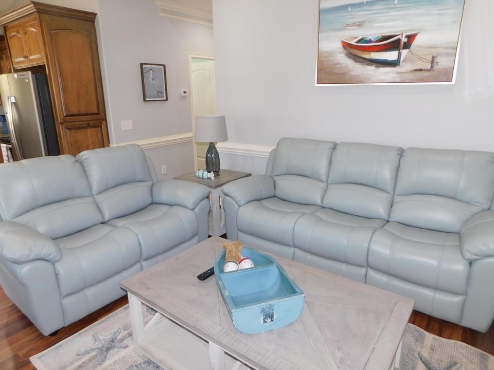 Living room with leather love seat and couch