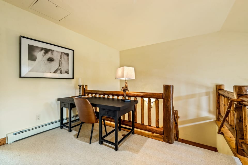A dedicated workspace on the upper landing makes remote work or trip planning easy