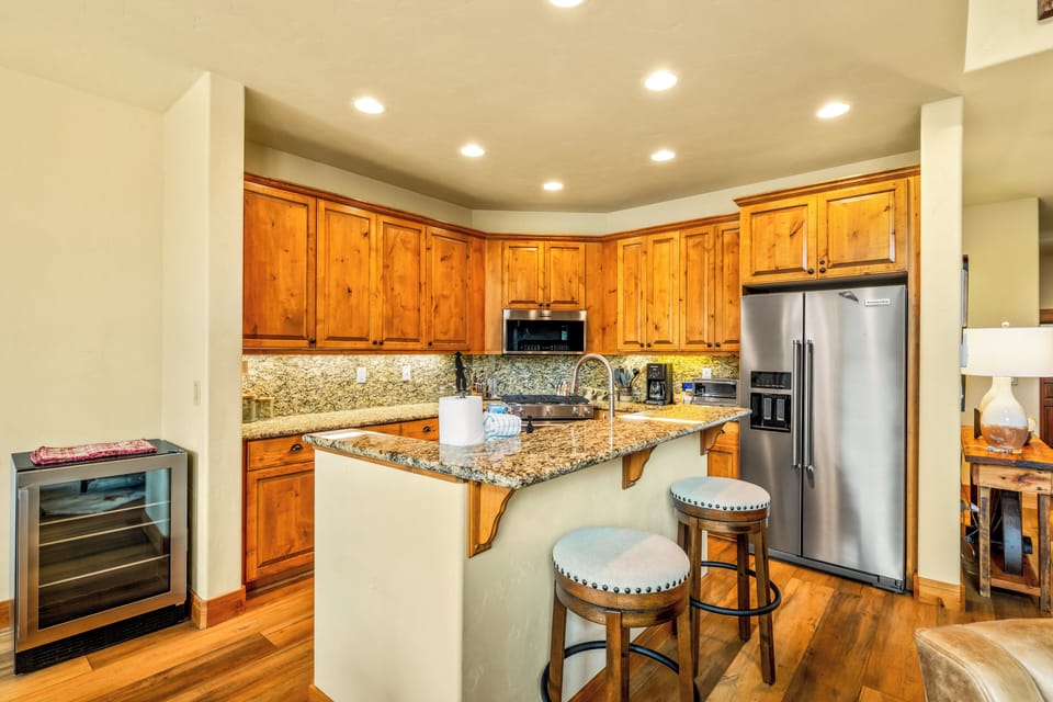Gather around the breakfast bar while meals come together in this spacious kitchen