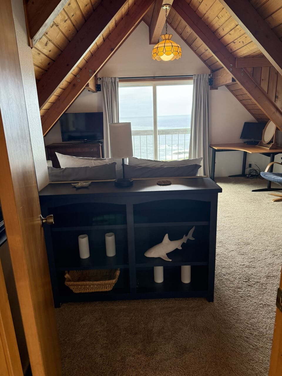 Primary Bedroom with a view. Crack the patio door and fall asleep to the waves.