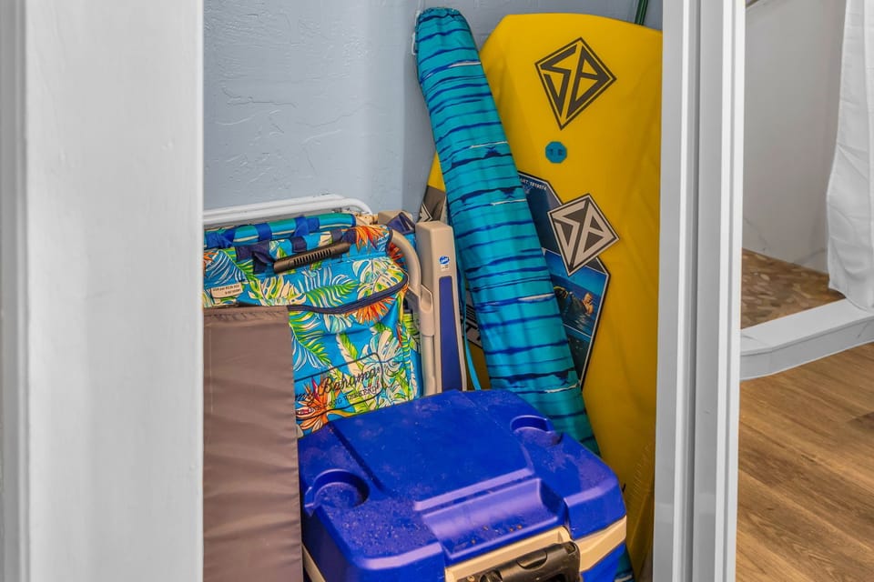 The storage closet holds boogie boards, a cooler, and beach chairs for your use