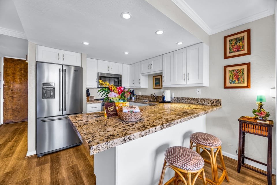 The kitchen features a breakfast bar with two stools for convenient seating  PKD-303