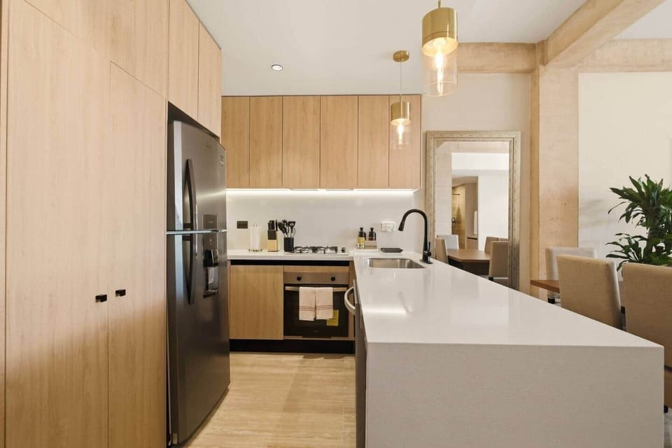 Fully equipped kitchen with everything you need to prepare and enjoy meals, including a refrigerator, microwave, coffee maker, toaster, blender, 4-burner stove, oven, dishwasher, and all essential cookware and silverware for a comfortable stay.