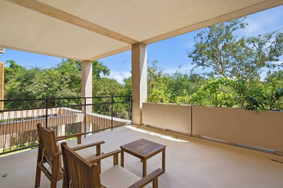 Private terrace surrounded by lush greenery, offering a peaceful outdoor space to unwind, enjoy your morning coffee, or relax and take in the natural views.