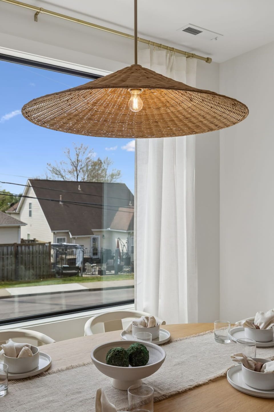 Dining Area: A sunlit dining space featuring wide windows and an inviting table setup.