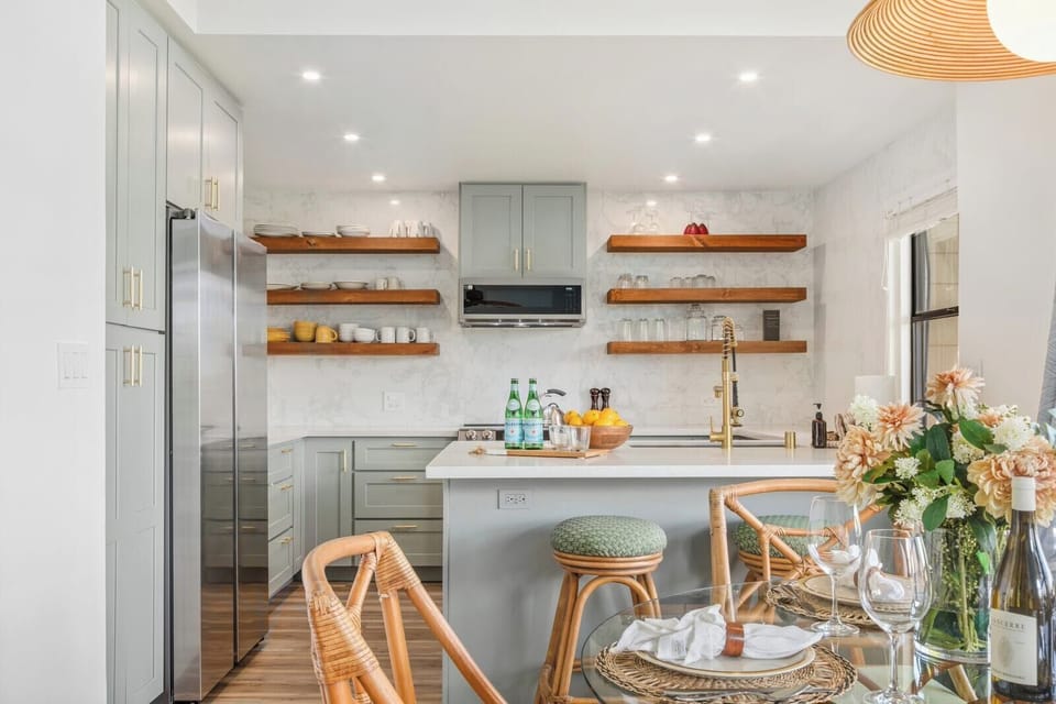 Bright kitchen with quartz counters, breakfast bar, and open shelving - newly renovated! KRV-514