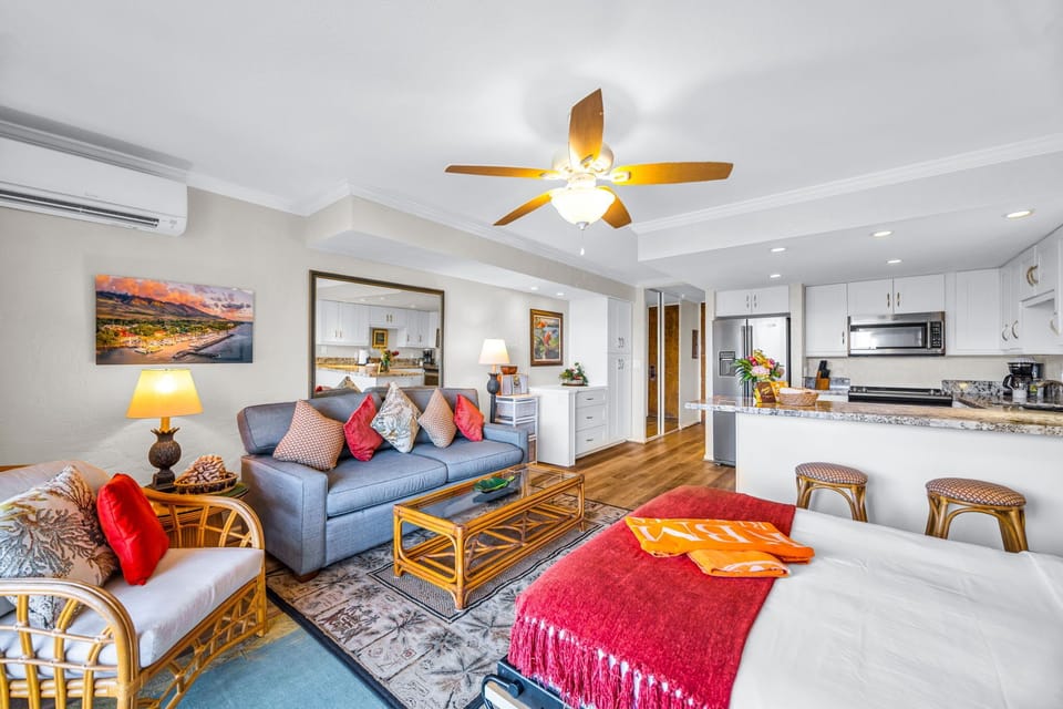 The living area opens toward the lanai with a comfortable sofa and rattan accents PKD-303