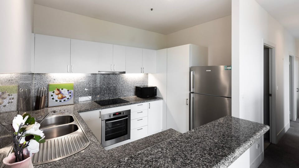 Fully equipped kitchen with appliances and generous bench space