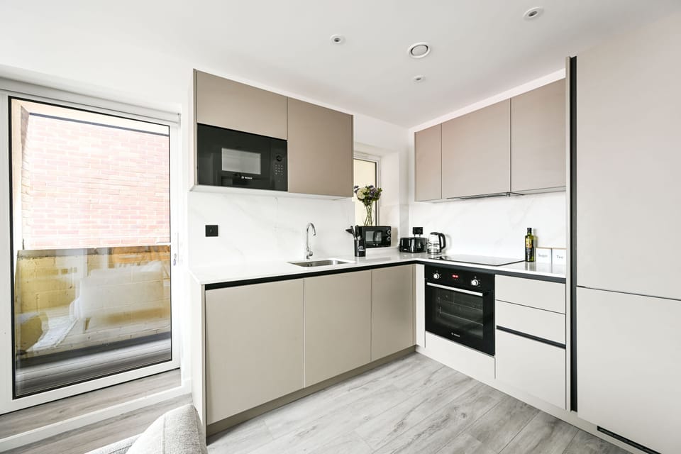 The kitchen opens straight onto the patio through the glazed door