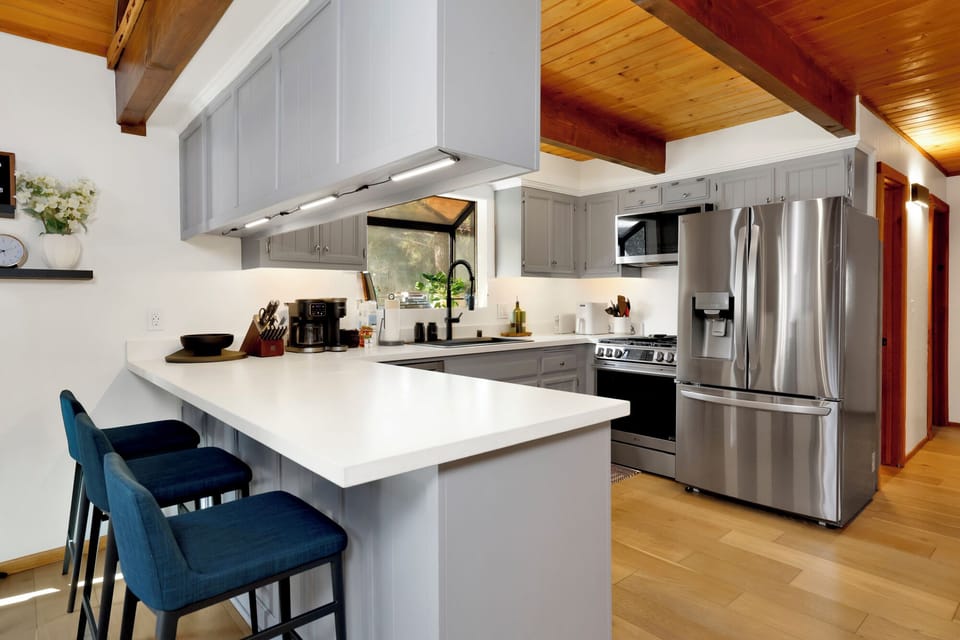 Fully equipped cabin kitchen with ample cabinetry, stove, fridge, microwave, and coffee maker—perfect for cooking meals, morning coffee, and feeling right at home on your stay.