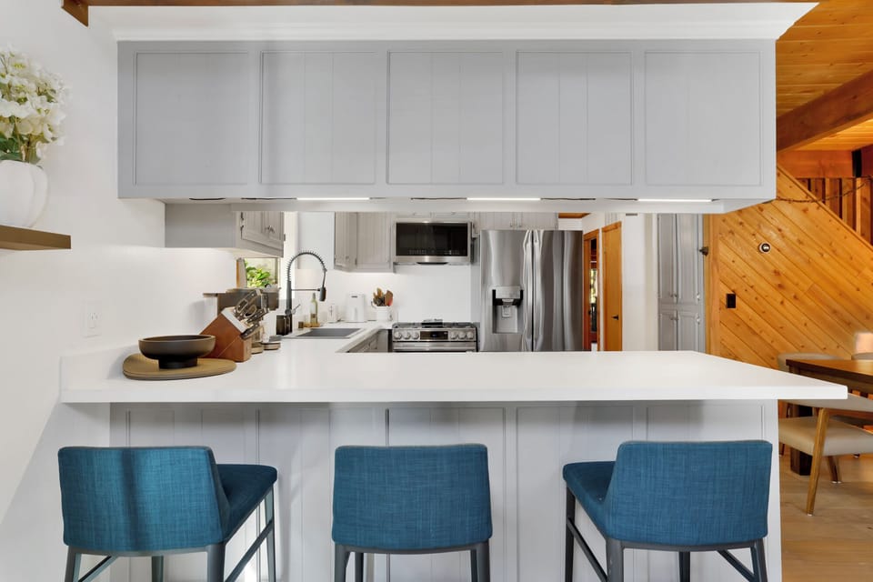 Fully equipped cabin kitchen with ample cabinetry, stove, fridge, microwave, and coffee maker—perfect for cooking meals, morning coffee, and feeling right at home on your stay.