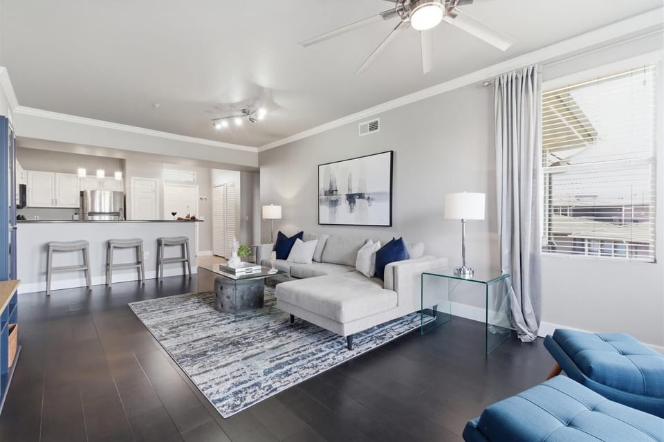 Bright and open living area featuring cozy furnishings, a Smart TV, fireplace, and access to the private balcony.